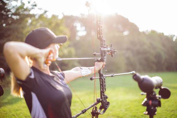A young female archer with a compound bow