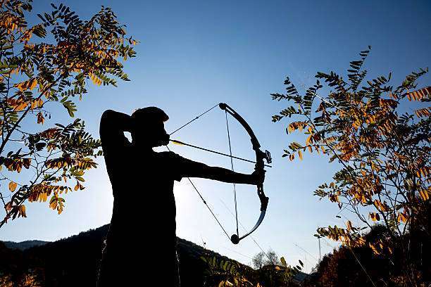 An archer drawing his compound bow