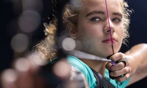 A young female archer with a compound bow