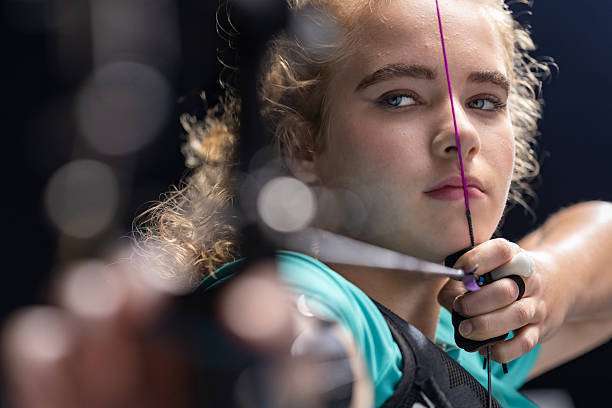 A young female archer with a compound bow