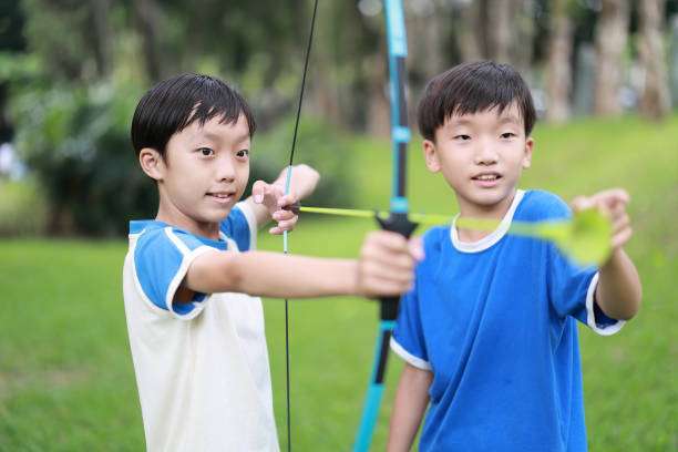 boy playing with a compound bow on a cold winter day.