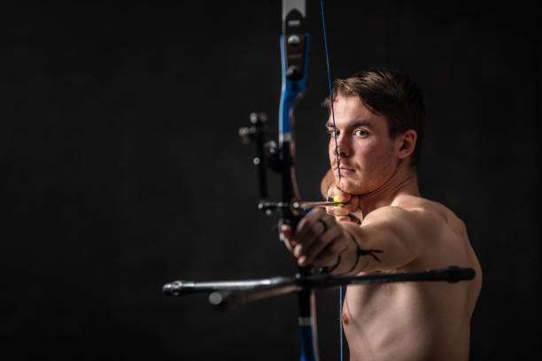 boy playing a compound bow