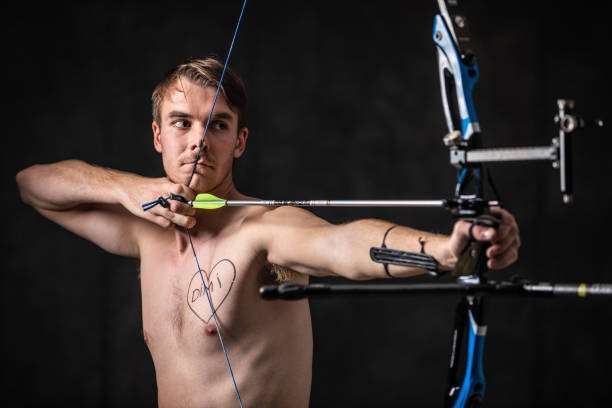 boy playing a compound bow