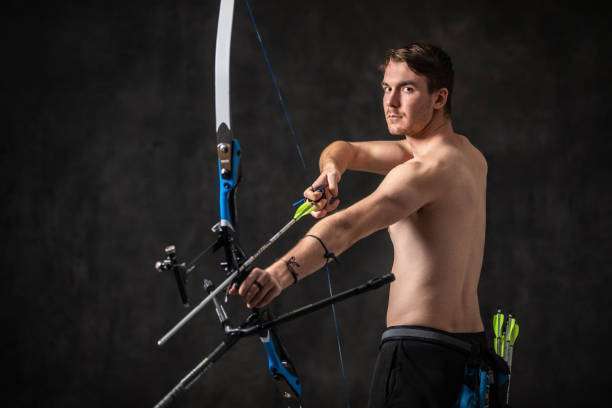 boy playing a compound bow
