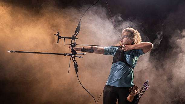 woman playing a compound bow