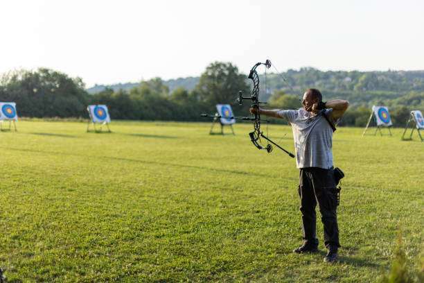 Man practicing archery training with compound bow