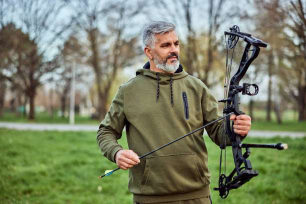 Man practicing archery training with compound bow
