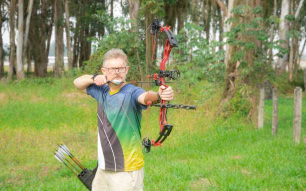 Man practicing archery training with compound bow